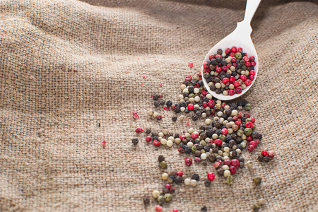 Black, white and mix peppers in sackingの写真素材