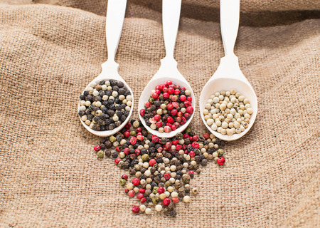 Black, white and mix peppers in sackingの写真素材