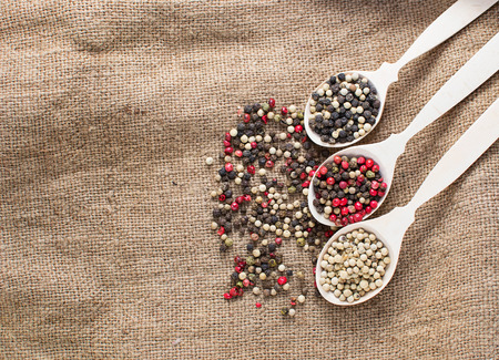 Black, white and mix peppers in sackingの写真素材