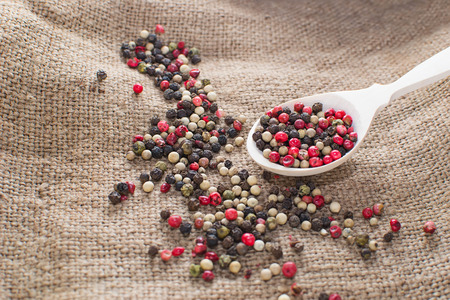 Black, white and mix peppers in sackingの写真素材