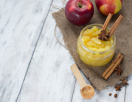 Apple jam in a jar on light wooden backgroundの写真素材