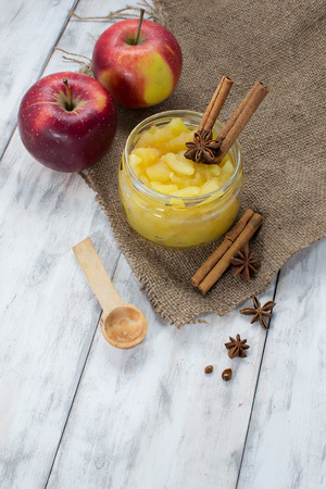 Apple jam in a jar on light wooden backgroundの写真素材