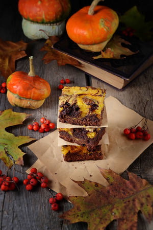 Pumpkin and chocolate cake brownies on wooden backgroundの写真素材