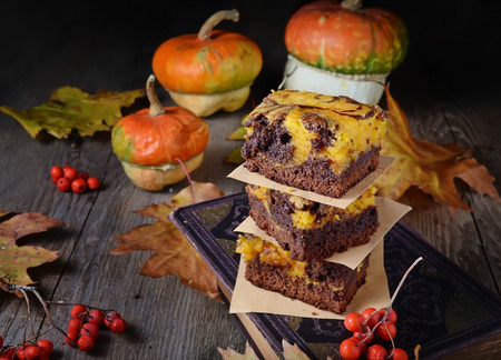 Pumpkin and chocolate cake brownies on wooden backgroundの写真素材