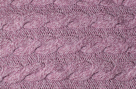 Pink knitted woolen background. Fabric texture