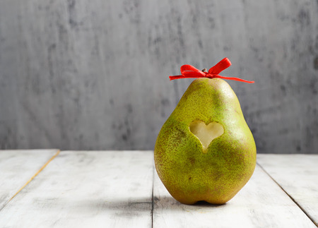Ripe fresh pear with heart for Valentine dayの写真素材