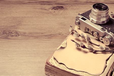 Retro camera and old book, toned photo. Selective focus. Space for textの写真素材