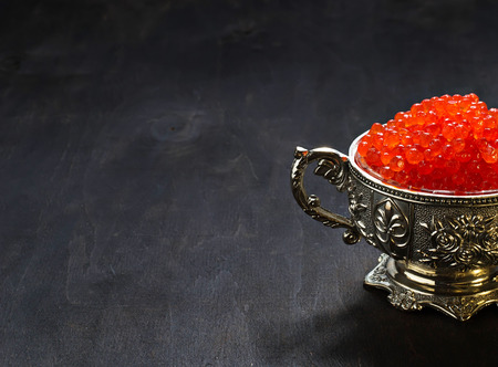 Red caviar in silver bowl. Selective focus, copy space backgroundの写真素材