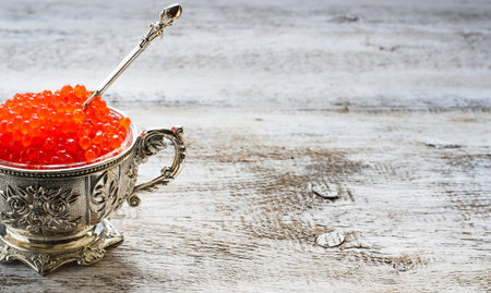 Red caviar in silver bowl. Selective focus, copy space backgroundの写真素材