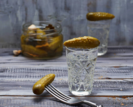 Glass of Russian vodka and pickled cucumber. Selective focusの写真素材