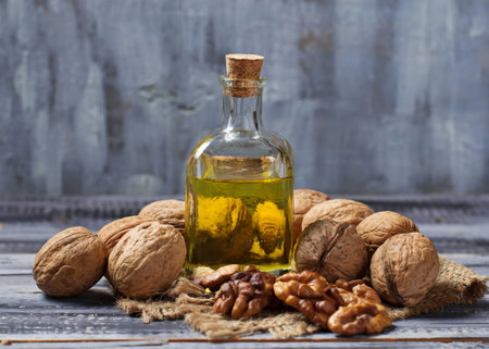 Walnut oil in bottle and nuts. Selective focus