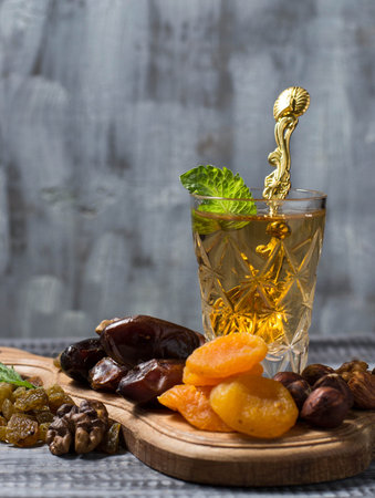 Traditional arabic tea and dry fruits. Selective focus