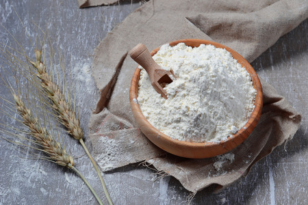 Wheat flour in wooden bowl. Selective focusの写真素材