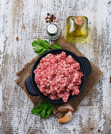 Raw minced meat with olive oil and garlic. Selective focusの写真素材