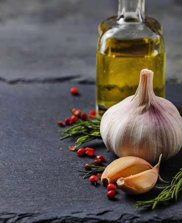 Garlic, pepper, rosemary and olive oil. Selective focusの写真素材