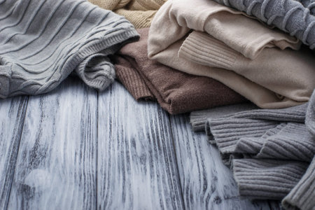 Warm knitted pastel sweaters. Selective focus