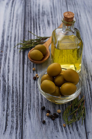 Olives and bottle of olive oil. Selective focusの写真素材