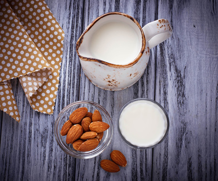 Almond milk and almonds on wooden background.  Selective focusの写真素材