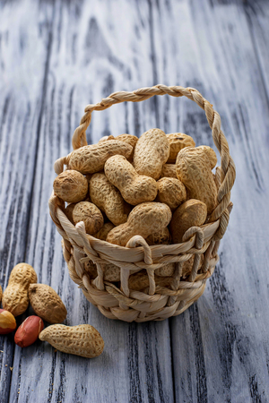 Peanuts in shell on wooden background. Selective focusの写真素材