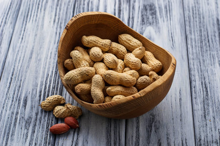 Peanuts in shell on wooden background. Selective focus