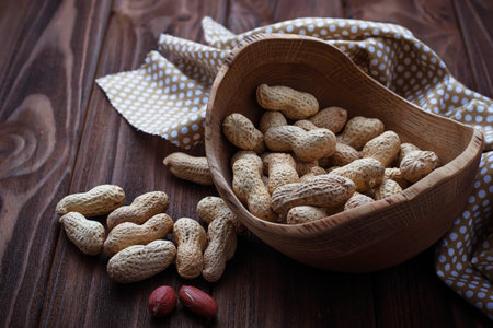 Peanuts in shell on wooden background. Selective focus