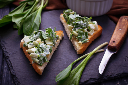 Bruschetta with ramson salad on slate background. Selective focusの写真素材