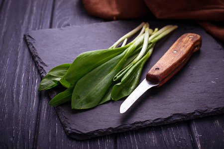 Ramson and knife on slate background. Selective focusの写真素材