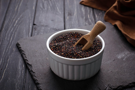 Uncooked black quinoa in bowl. Selective focusの写真素材