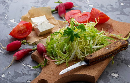 Ingredient for salad cabbage, radish, tomato and feta. Selective focusの写真素材