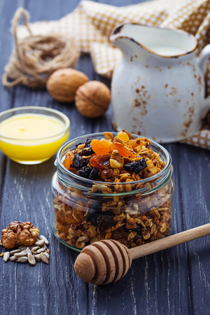 Granola in jar with nuts and dried fruit. Selective focusの写真素材