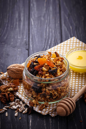 Granola in jar with nuts and dried fruit. Selective focusの写真素材