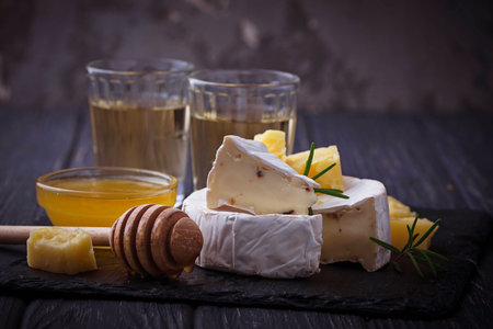 Camembert cheese with honey and wine. Selective focus.