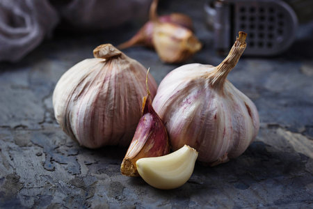 Fresh garlic on concrete background. Selective focus