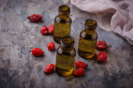 Dog rose essential oil on small bottles. Selective focusの写真素材