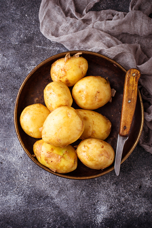 Raw potato in basket. Selective focusの写真素材