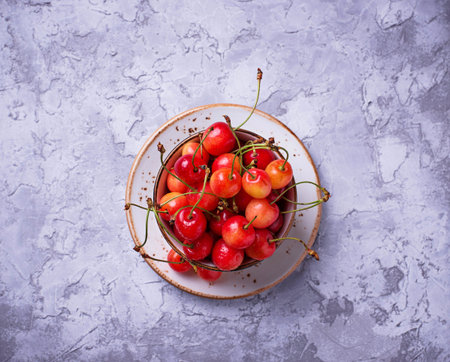 Fresh ripe cherry on concrete background. Selective focus