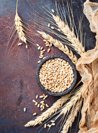 Wheat grains and spikelets on rusty backgroundの写真素材