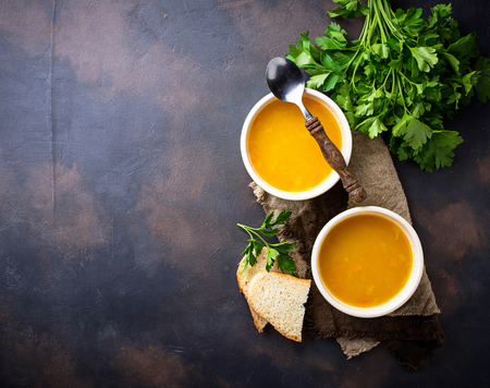 Bowls of hot vegetarian red lentil soupの写真素材