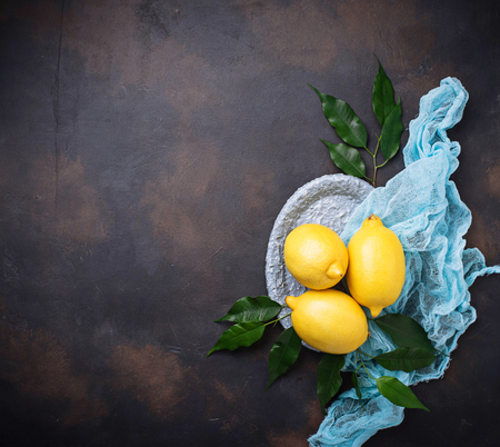 Fresh juicy lemons on rusty background. Selective focusの写真素材