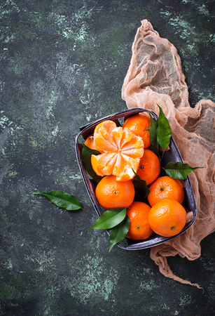 Fresh ripe tangerines with leavesの写真素材