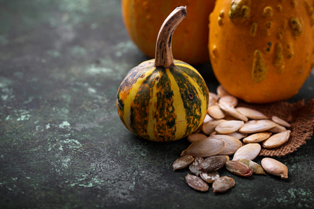 Raw and roasted pumpkin seeds. Selective focusの写真素材