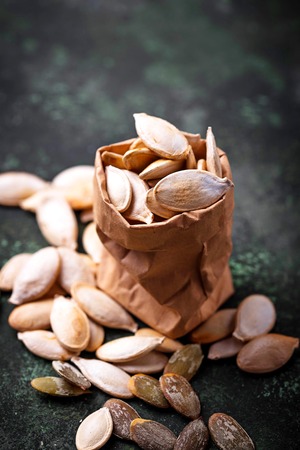 Raw and roasted pumpkin seeds. Selective focusの写真素材