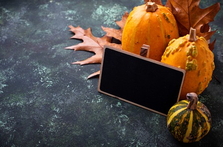 Autumn background with pumpkins and dried leavesの写真素材