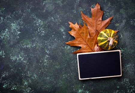 Autumn background with pumpkins and dried leavesの写真素材