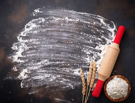 Wheat flour, ears and rolling pin. Top view, space for textの写真素材