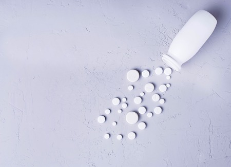 Different pills and tablets on grey background. Top viewの写真素材