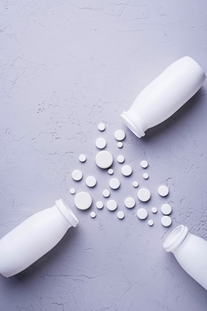 Different pills and tablets on grey background. Top viewの写真素材