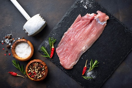 Raw meat steak with spices on rusty backgroundの写真素材