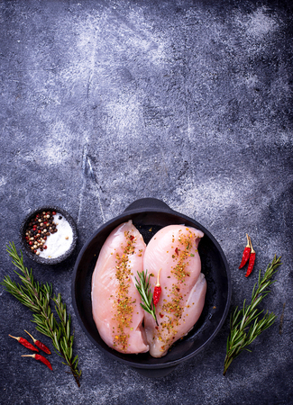 Raw chicken fillet in cast iron panの写真素材