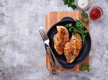 Grilled chicken breast or fillet on iron panの写真素材